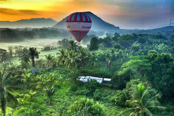 Hot Air Balloon Ride: 7 Magical Secrets to See Dambulla from Above 4 Passengers enjoying a magical Hot Air Balloon Ride Dambulla, witnessing the sunrise during their Safari Combo Package adventure.